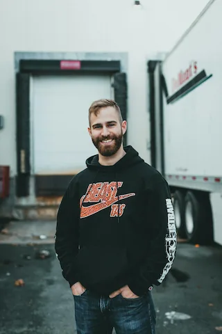 A trucker unloading his cargo at a receiver